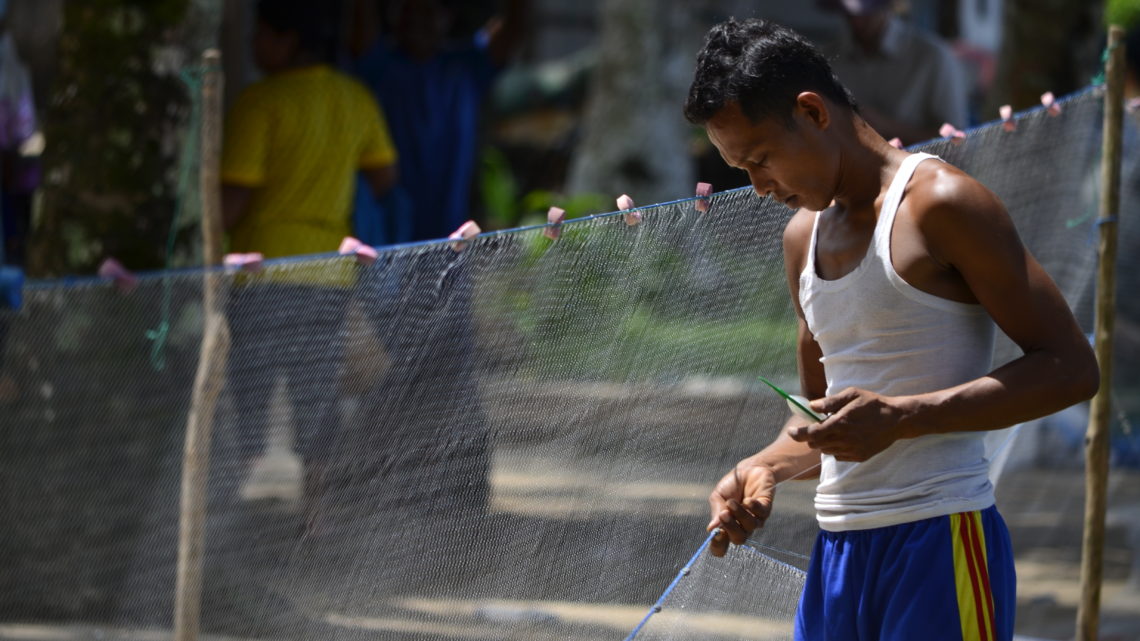 Man repairing a net